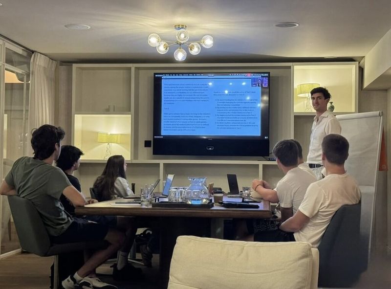 An instructor walks students through an SAT reading passage on screen during the London boot camp.
