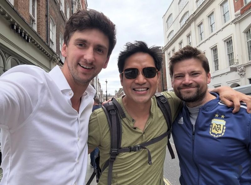 Dan Lerman takes a street selfie with two colleagues on a London street.