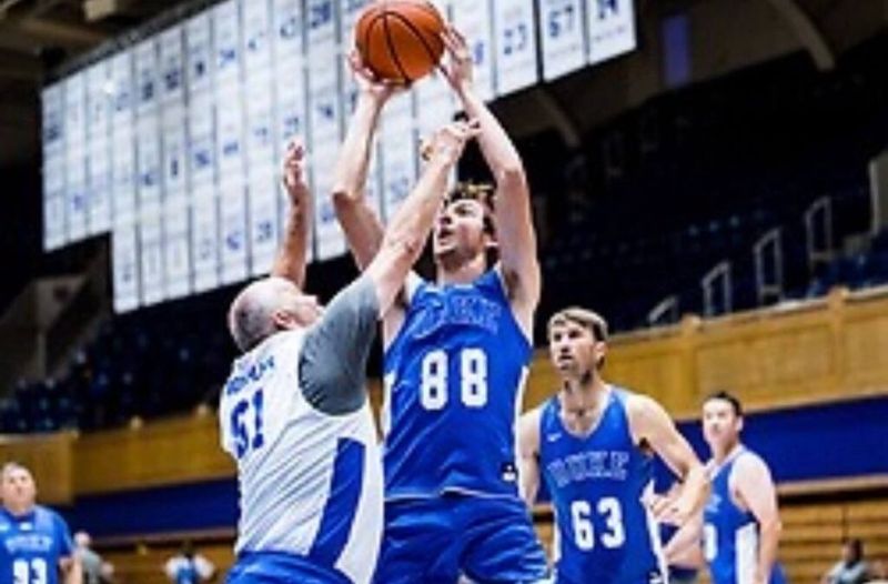 Dan Lerman (No. 88) shoots over a defender during a Coach K Academy game at Duke's Cameron Indoor Stadium.